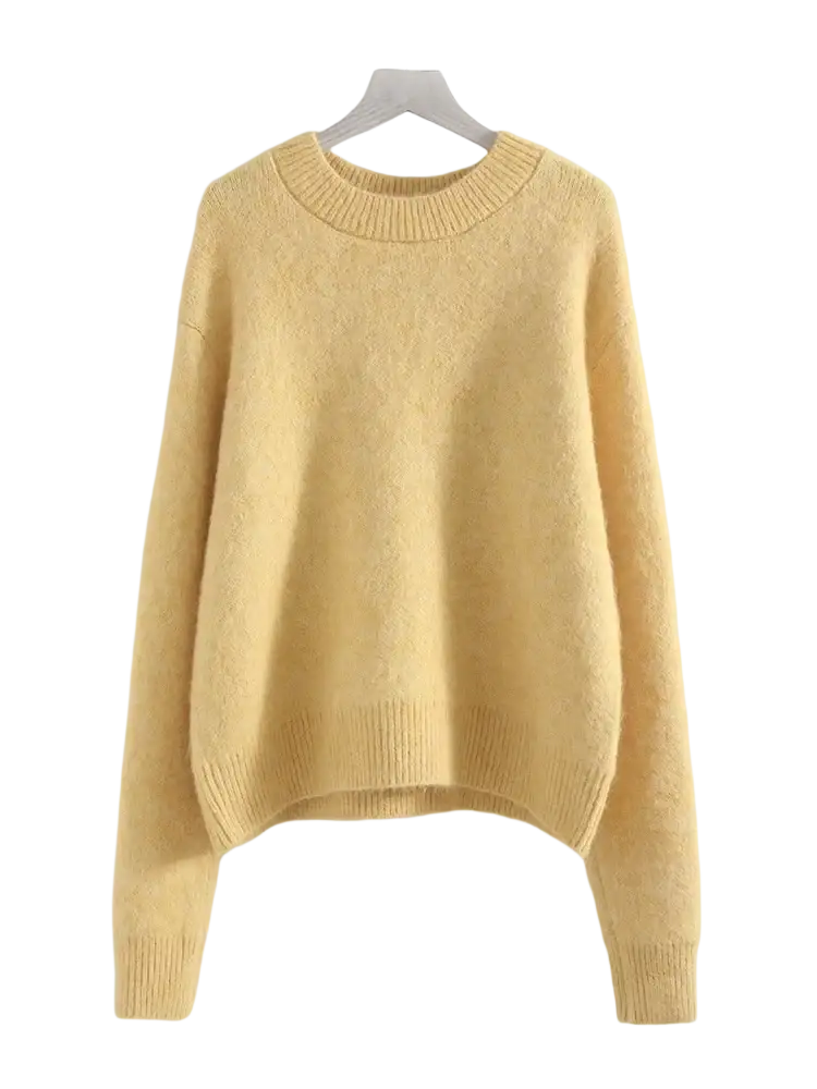 A soft pale yellow women winter knit pullover sweater with cozy textured fabric and ribbed cuffs