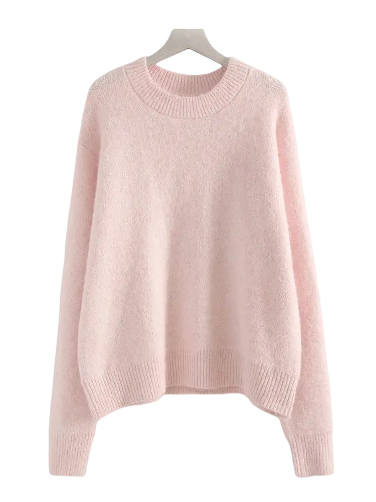 A soft pastel pink oversized knit sweater with ribbed crew neckline and cuffs for women winter wear