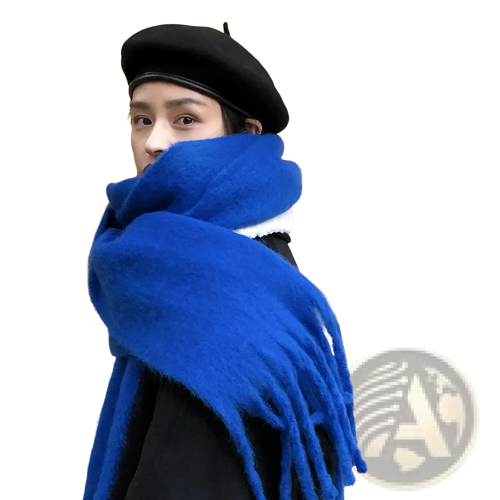 A vibrant royal blue women winter warm solid color pashmina shawl scarf with thick texture and soft fringed ends