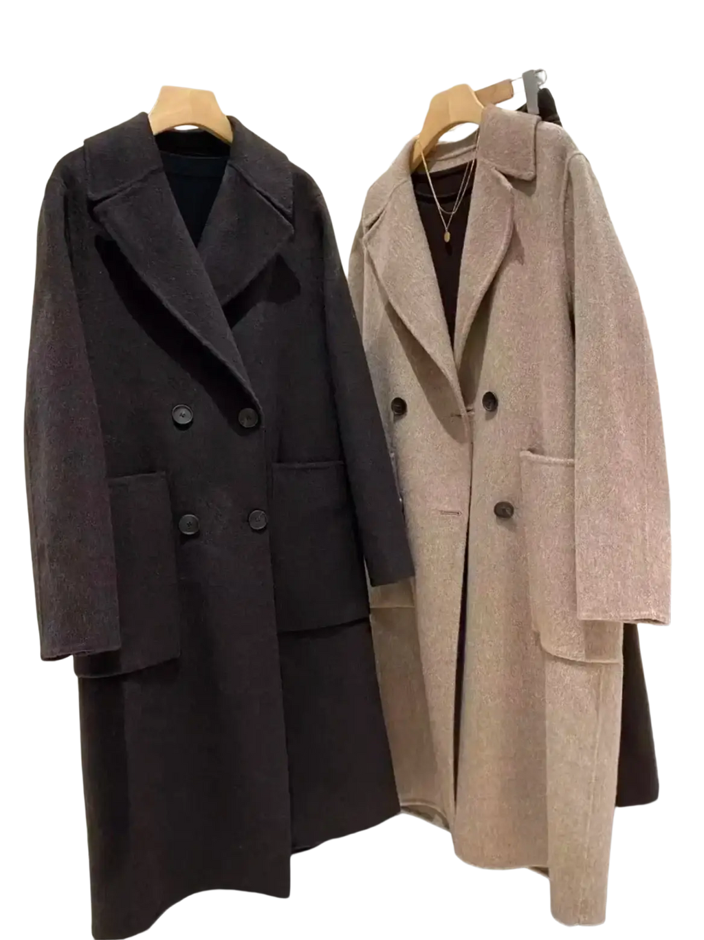 Two wool blend double breasted coats in beige and dark charcoal hang on wooden hangers for women