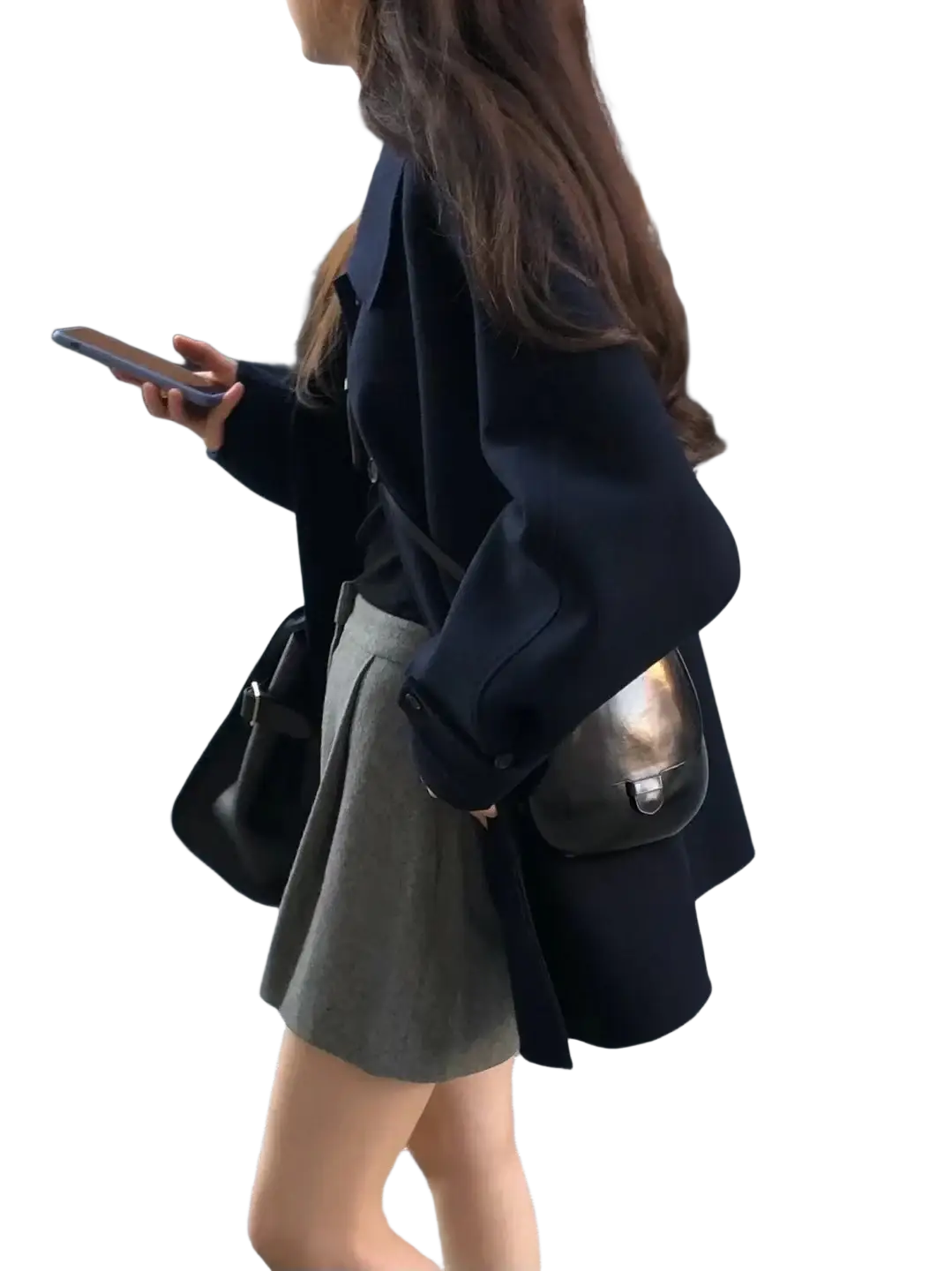 Black leather shoulder bag with metallic silver clasp and flap closure paired with women woolen coat elegant lapel mid-length