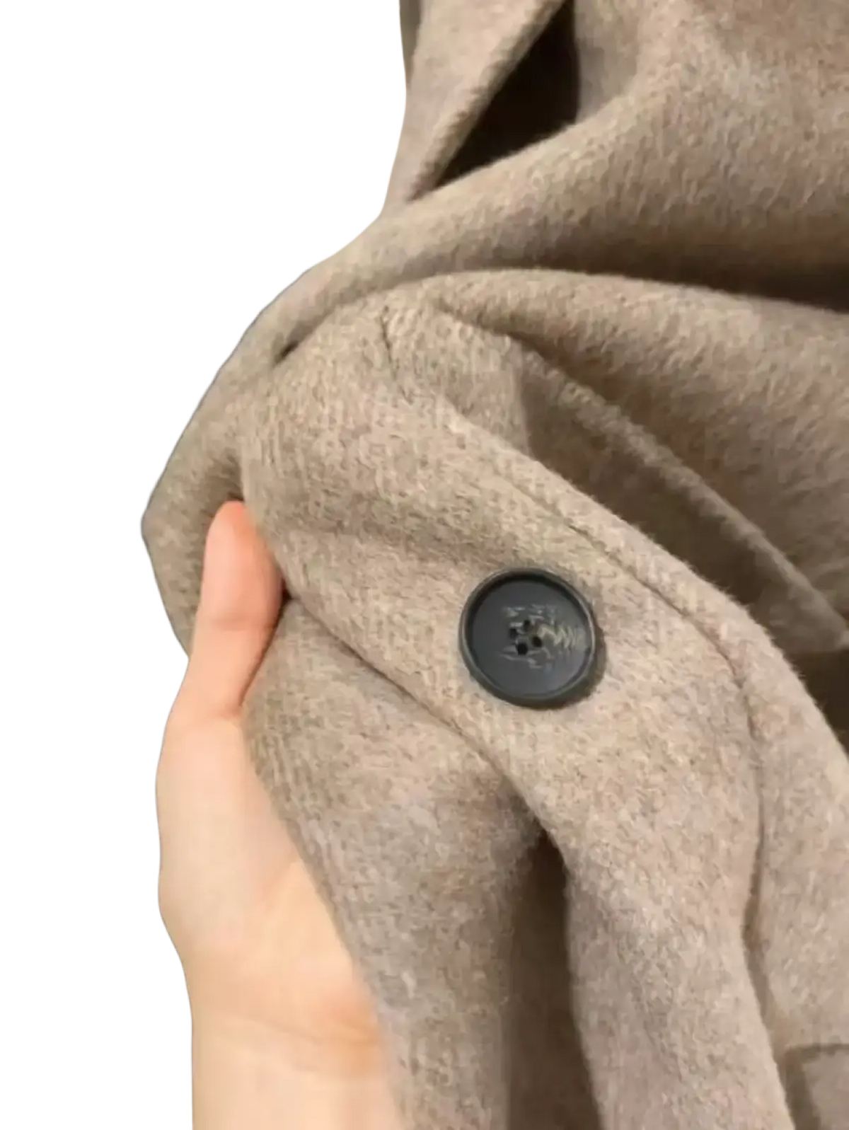 A dark gray textured button sewn on a soft beige double-breasted wool overcoat for women