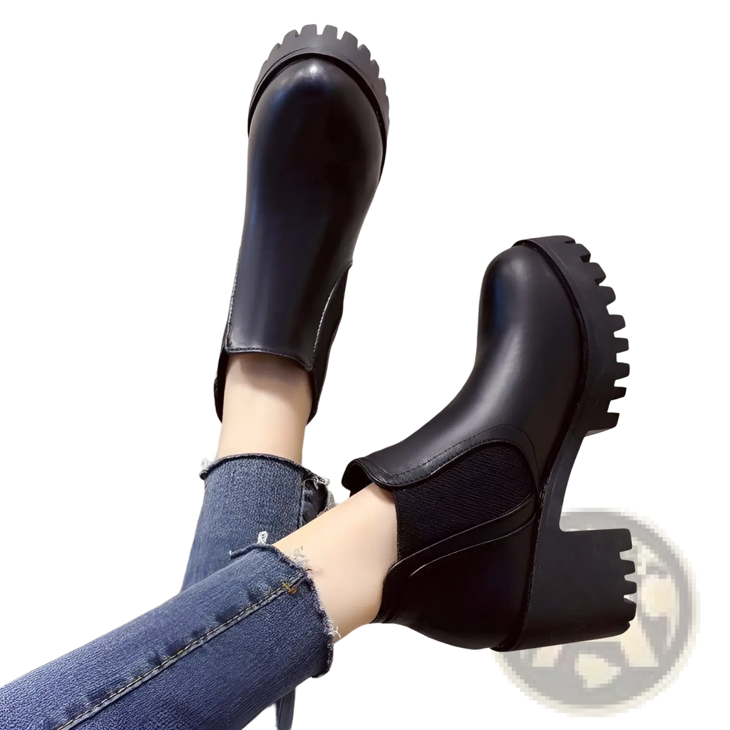 Women black leather Chelsea boots with chunky textured soles and mid-height block heels for ankle wear