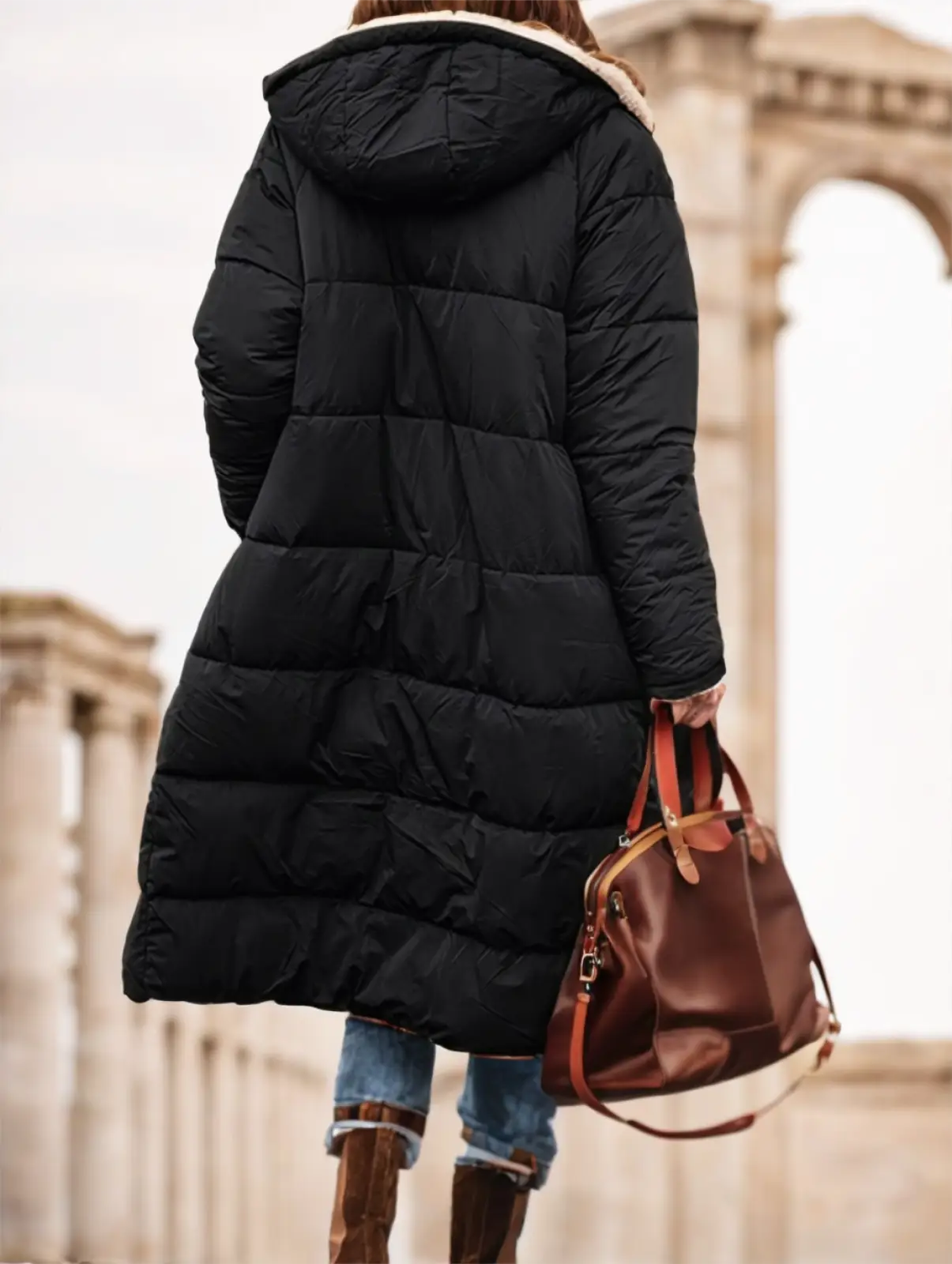 Women’s black shearling lined puffer jacket with quilted design and plush beige-lined hood for cold weather wear