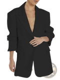 Black oversized women’s casual blazer with deep v-neckline and rolled-up sleeves tailored for office wear