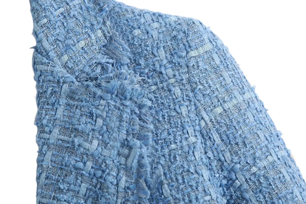 Women’s double breasted light blue blazer made of textured tweed fabric with woven pattern and frayed edges