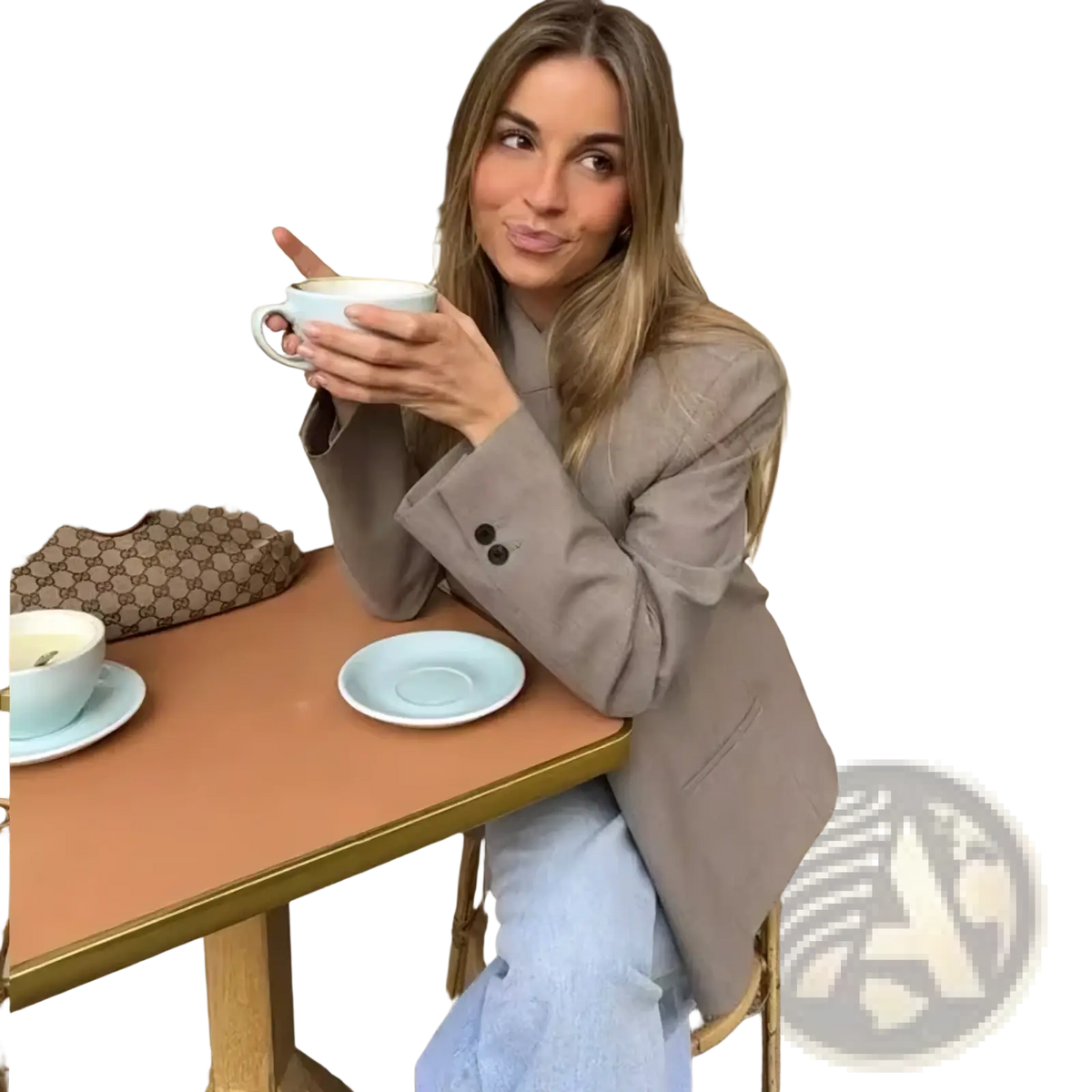 Light blue ceramic coffee cup with matching saucer on table alongside a women’s elegant stand collar casual blazer jacket