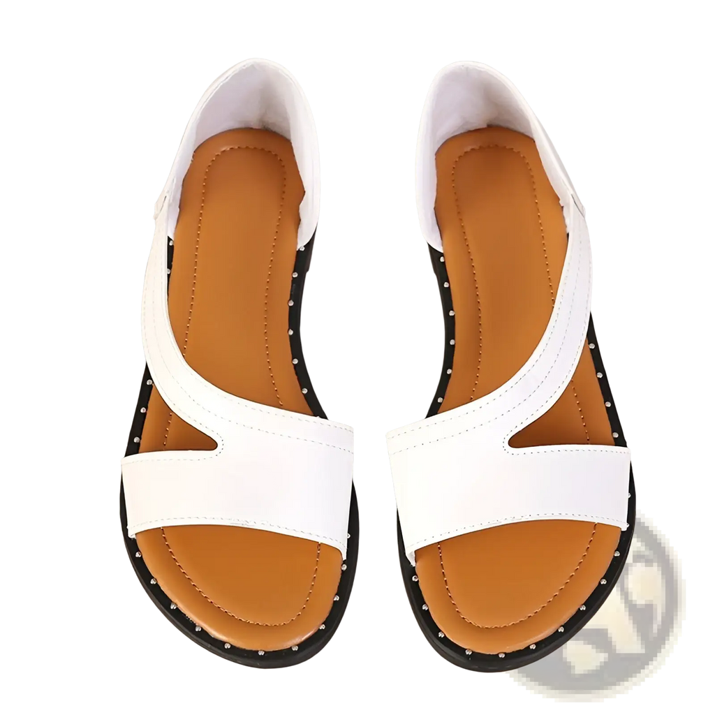 White leather women’s flat sandals with black studded soles and tan insoles minimalist strappy shoes