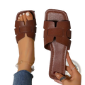 Womens flat slide sandals in brown leather with textured reptile skin pattern and h-shaped strap design for casual wear