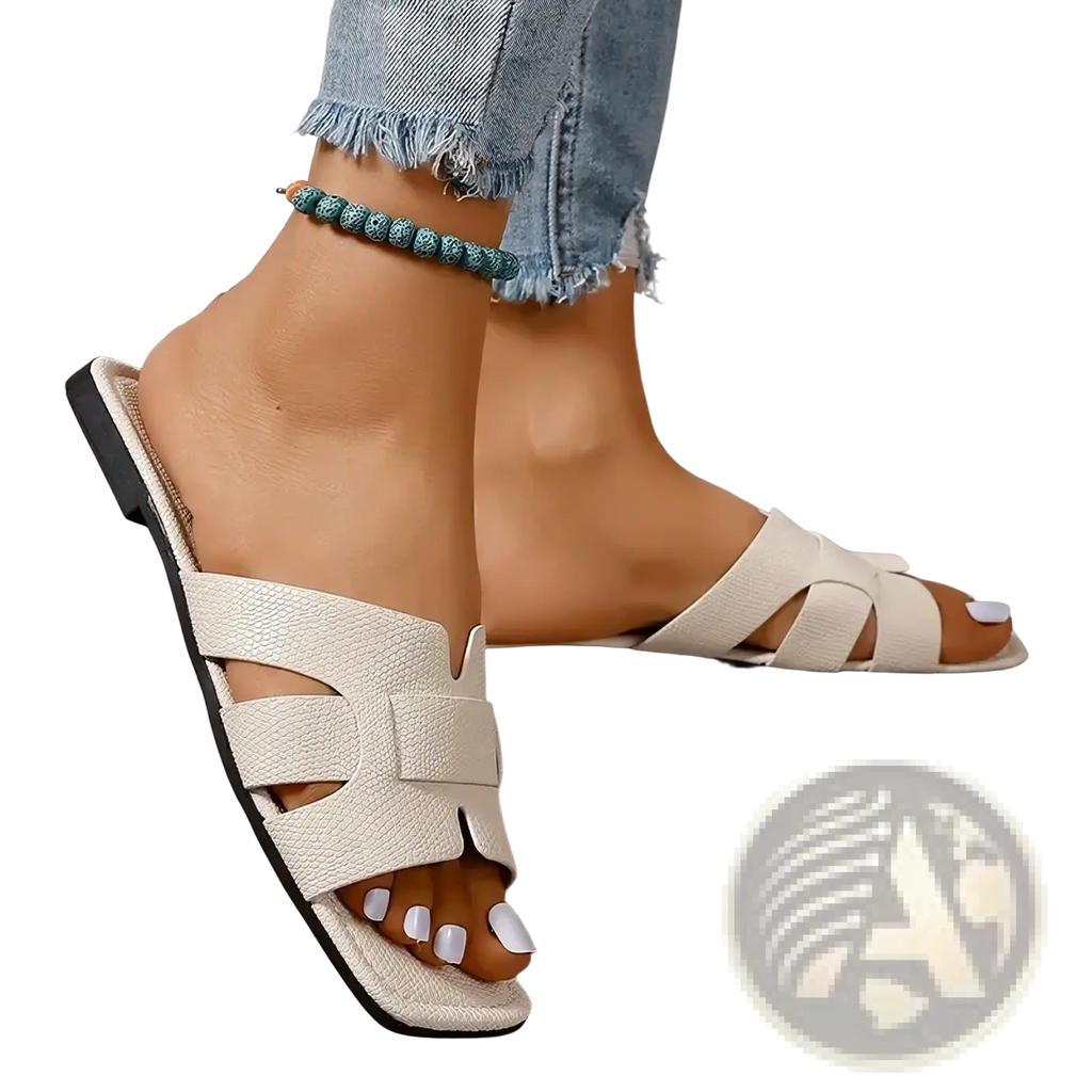 Womens flat slide sandals with white textured leather crisscross straps and black sole for casual summer beachwear