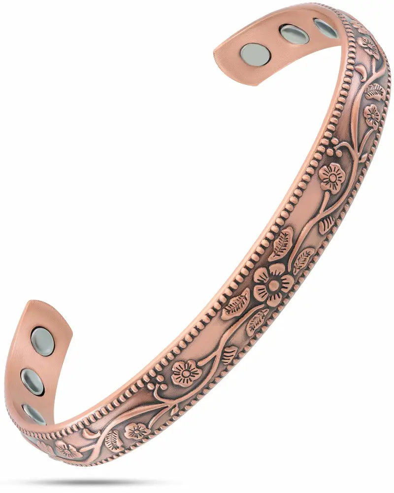 Rose gold-toned floral copper magnetic therapy cuff bracelet with intricate vine embossing along its length