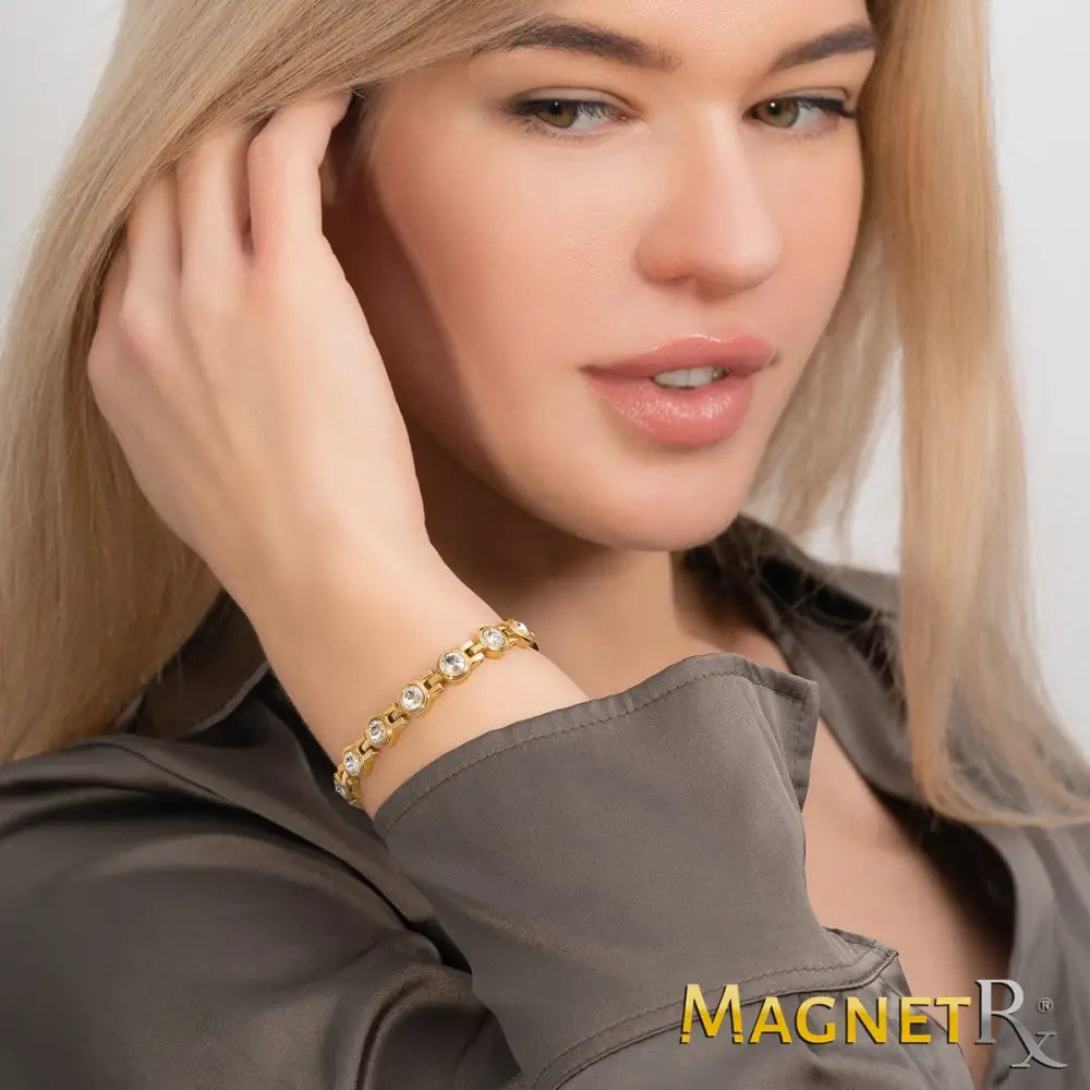 Women’s gold crystal magnetic therapy link bracelet featuring round clear stones in an elegant linked design