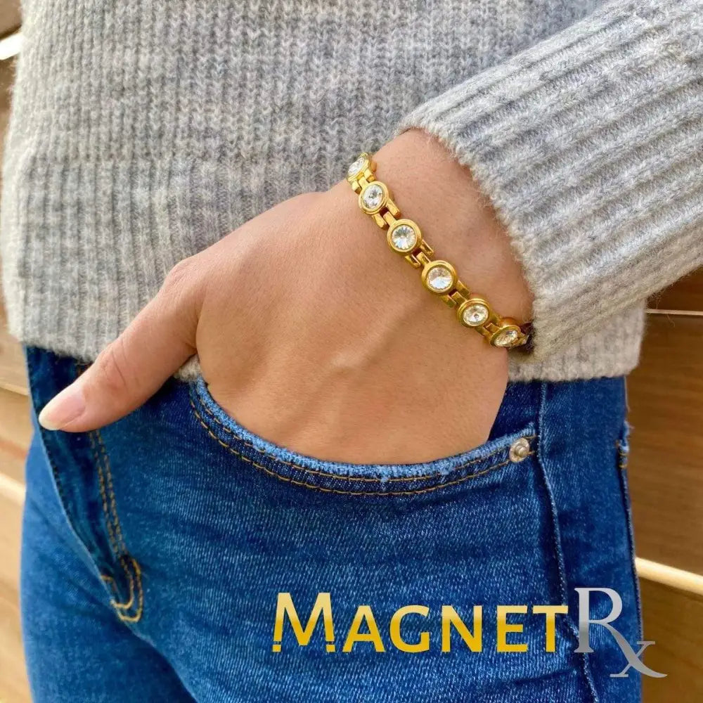 Women’s gold crystal magnetic therapy link bracelet featuring gold-toned linked design with clear round stones