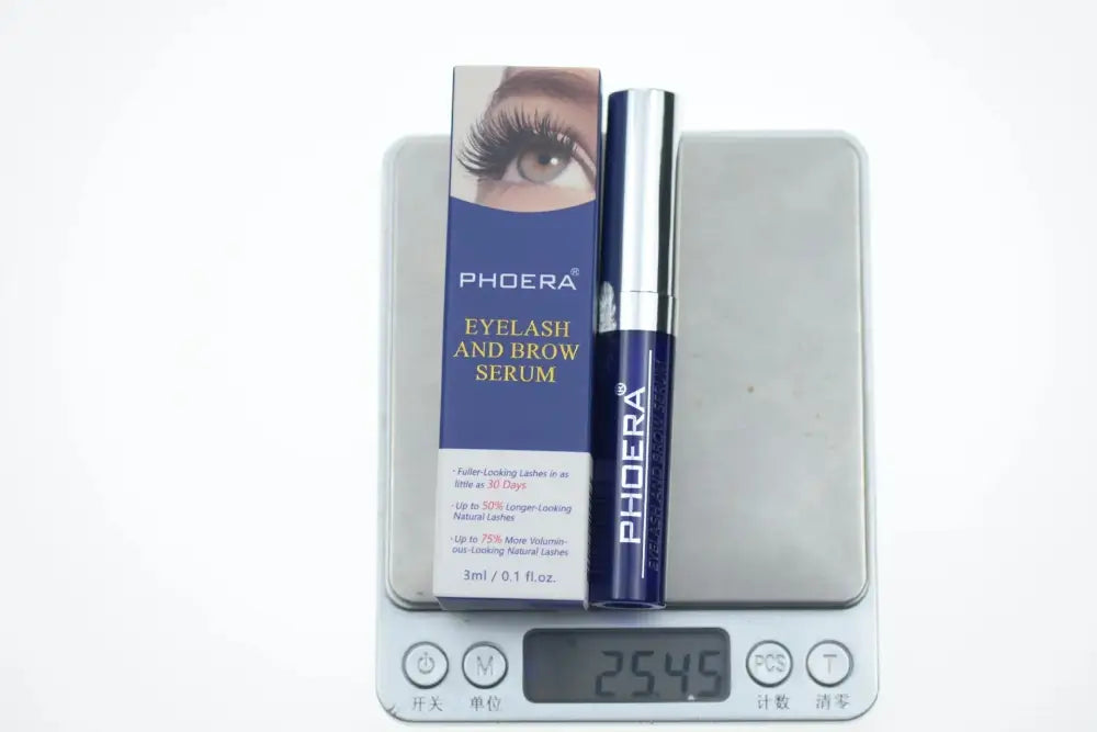 Phdera volumizing and lengthening smudge proof mascara 3g in sleek blue tube with silver cap beside matching box on digital scale