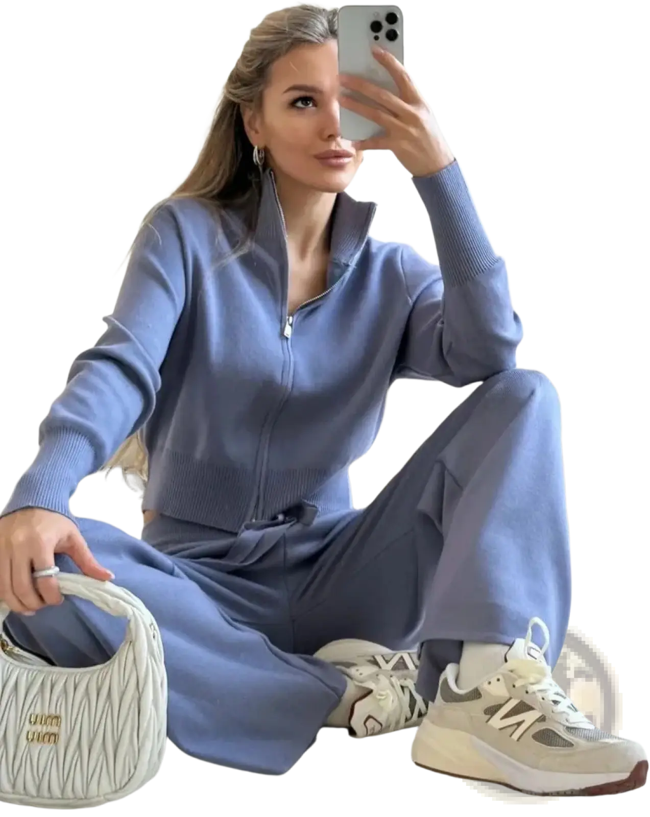 A white quilted handbag with gold-tone branding paired with a women’s knit zip up cardigan and wide leg pant set