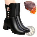 Black leather women’s martin boots featuring a decorative floral brooch and rhinestone accents on the side