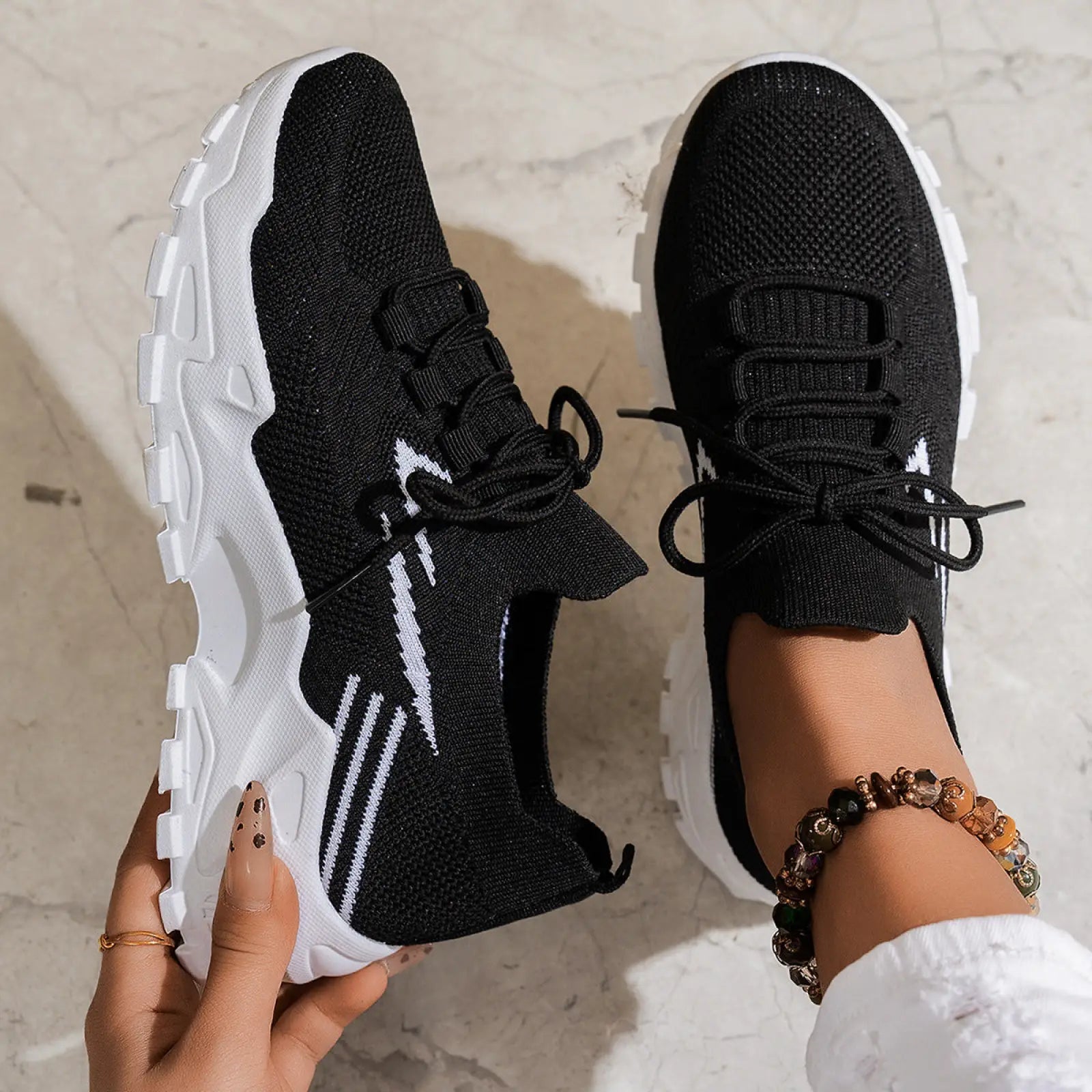 Women’s lightweight breathable mesh lace up sports shoes in black knit with white chunky soles and side stripes