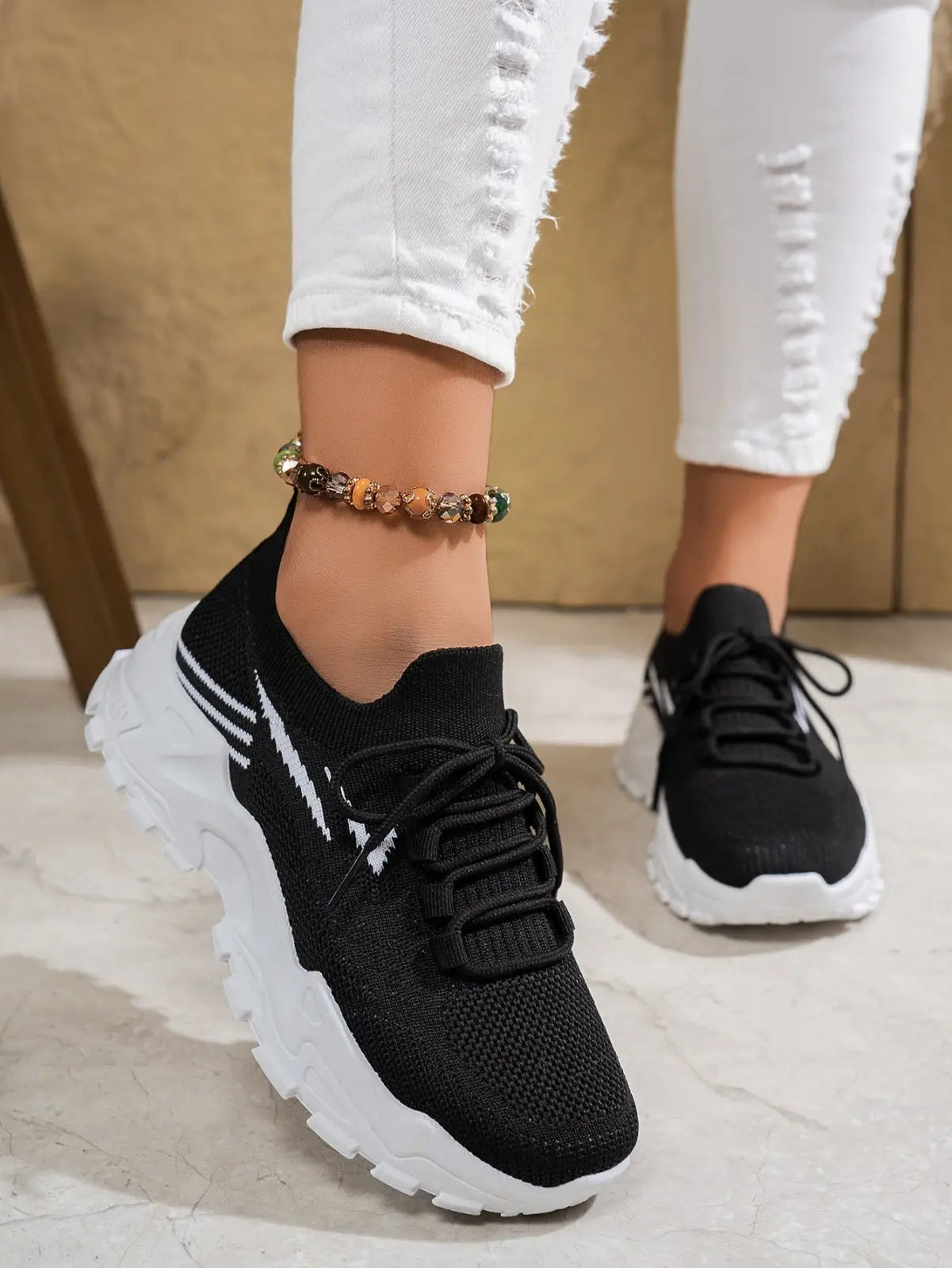 Black knit women’s lightweight breathable mesh lace up sports sneaker with white chunky sole and side stripes