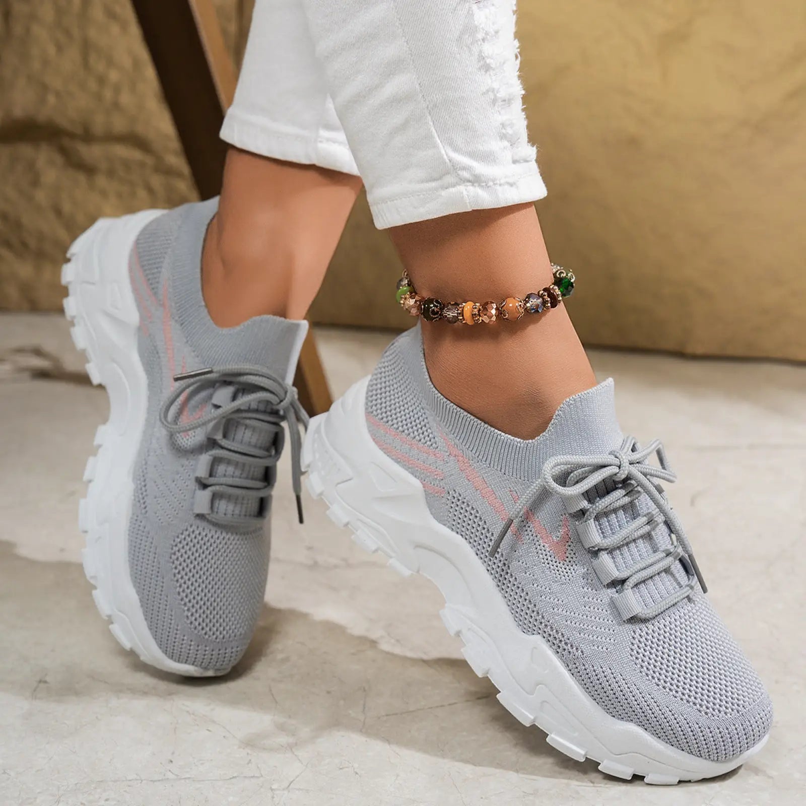 Women’s lightweight breathable mesh lace up sports shoes in gray knit with chunky white sole and pink accents