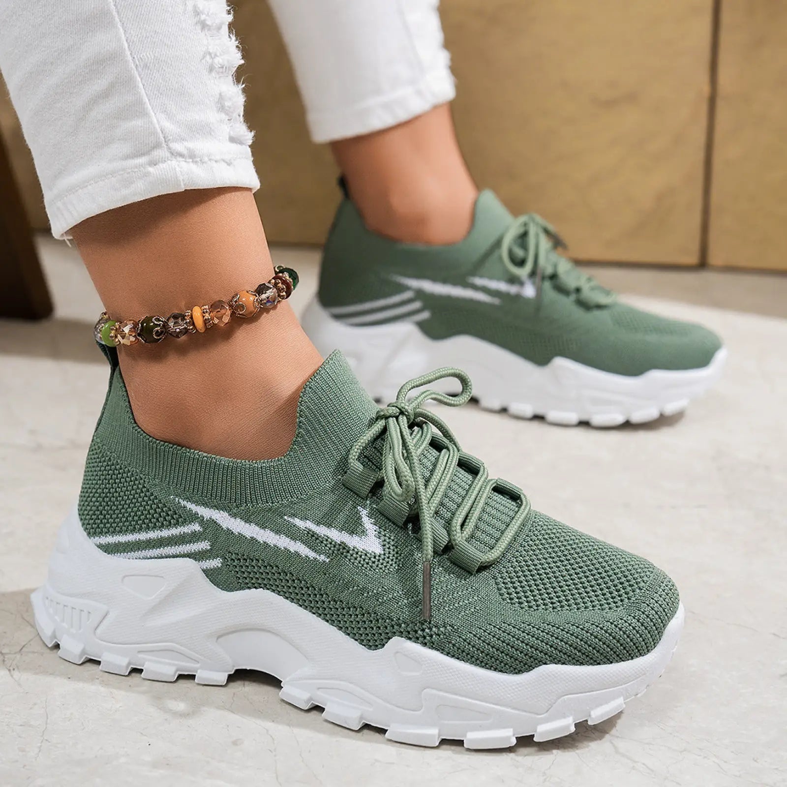 Women’s olive green knit lightweight breathable mesh lace up sports shoes with white swoosh and chunky white soles