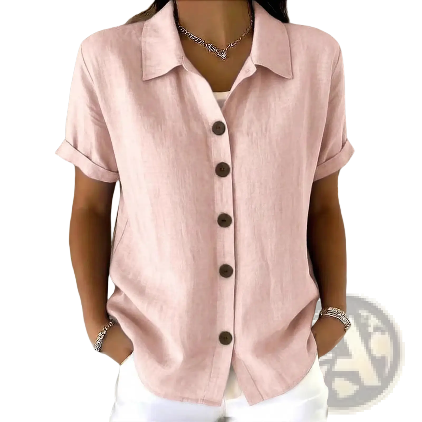A soft pink women’s linen blend short sleeve shirt with rolled cuffs, collar, and dark brown buttons