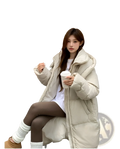 Beige women’s long quilted winter puffer coat with plush design and soft shearling lining for cold weather