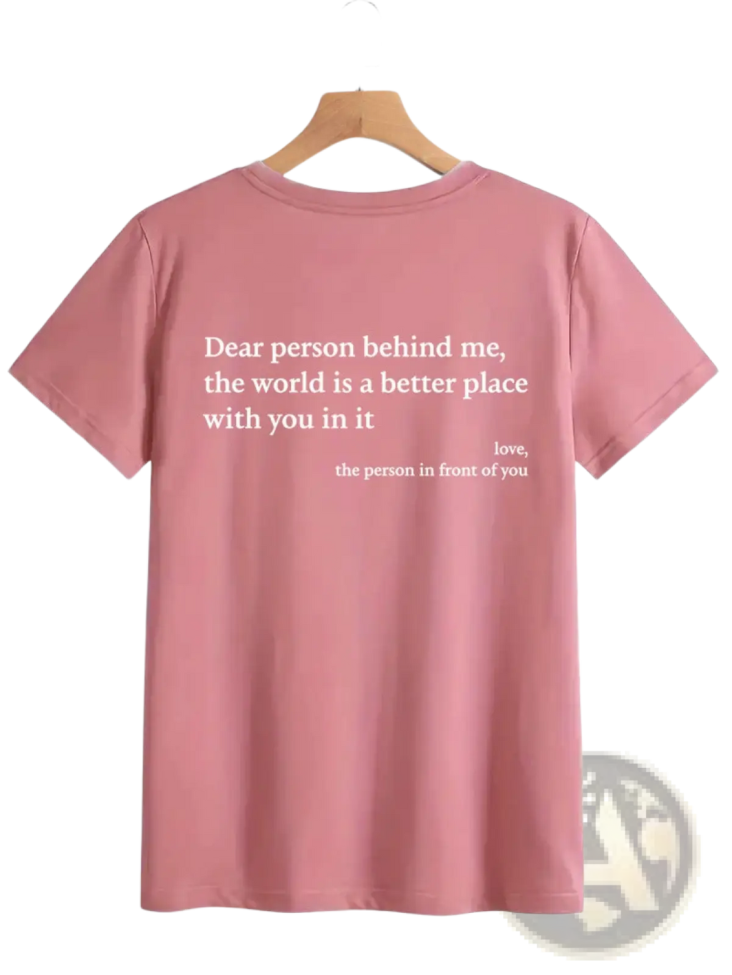 Back view of a soft pink women’s oversized short-sleeved cotton t-shirt with a white slogan print