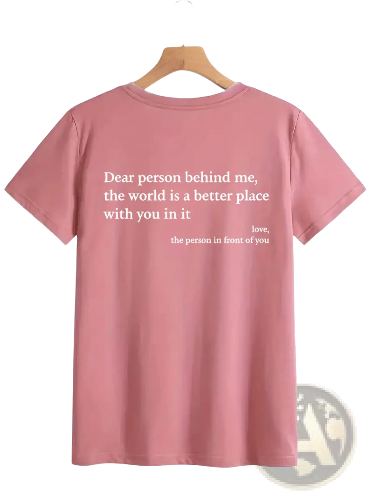 Back view of a soft pink women’s oversized short-sleeved cotton t-shirt with a white slogan print