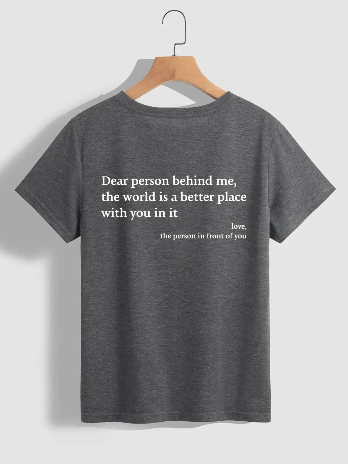 Back view of a women’s oversized dark gray heathered cotton t-shirt with white slogan print on the back