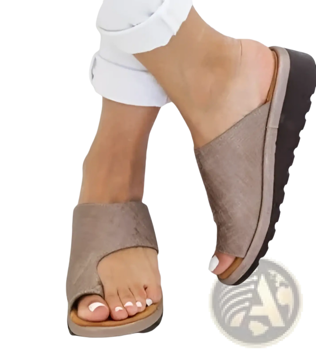 Women’s platform slide sandals in tan leather with thick black rubber sole and open-toe design for beach use