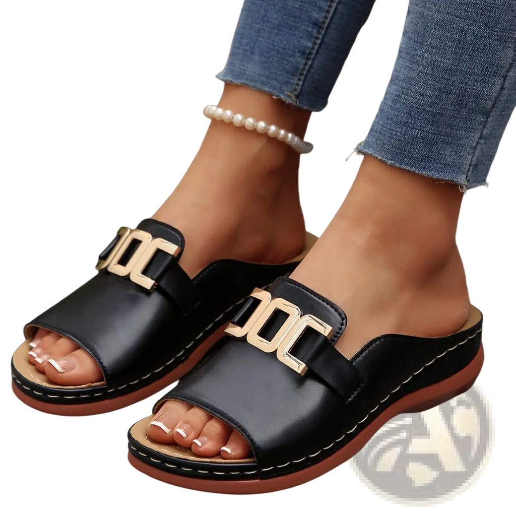 Women’s black leather platform wedge slide sandals with gold-tone joc buckle accents and tan rubber sole