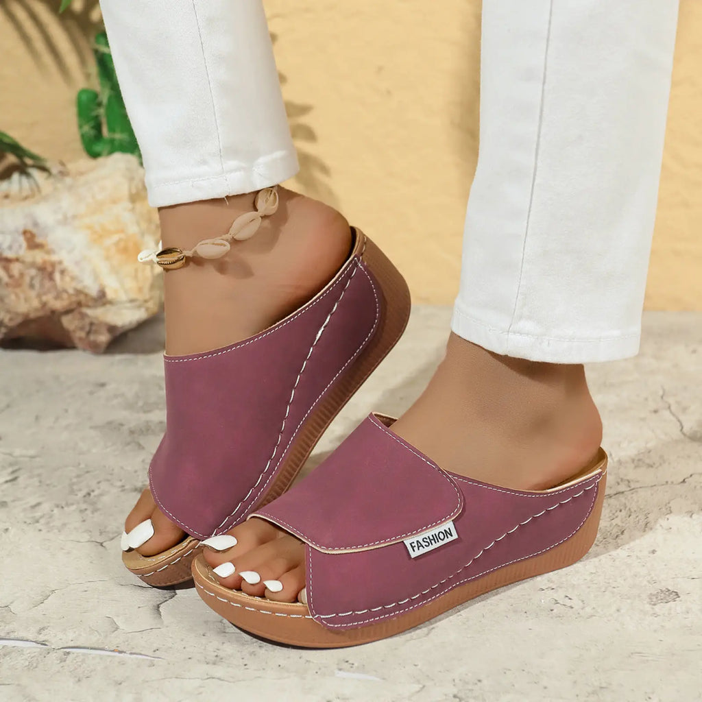 Purple women’s platform wedge summer slide sandals with white stitching and a fashion label on the side