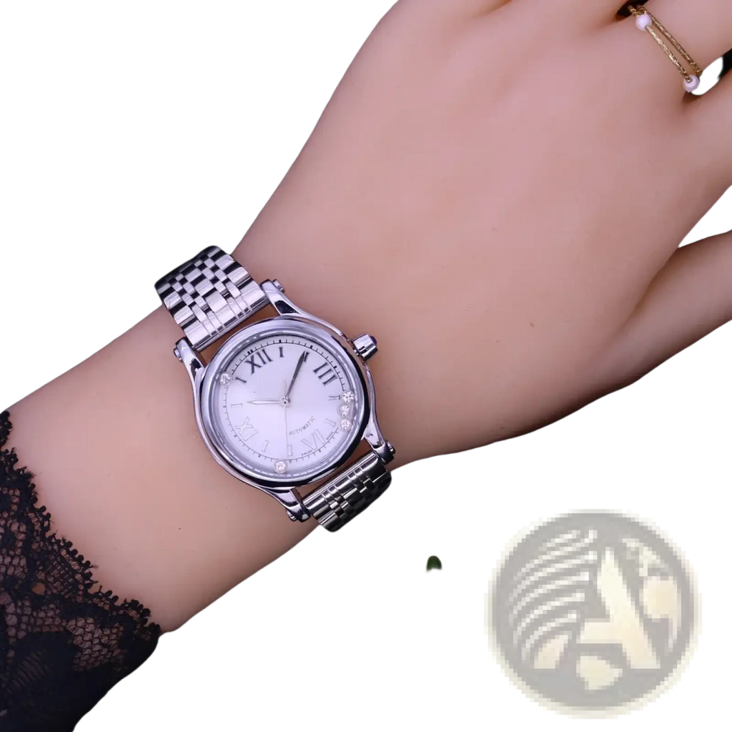 Silver-toned stainless steel women’s quartz leather dress watch with white dial, roman numerals, and crystal bezel accents