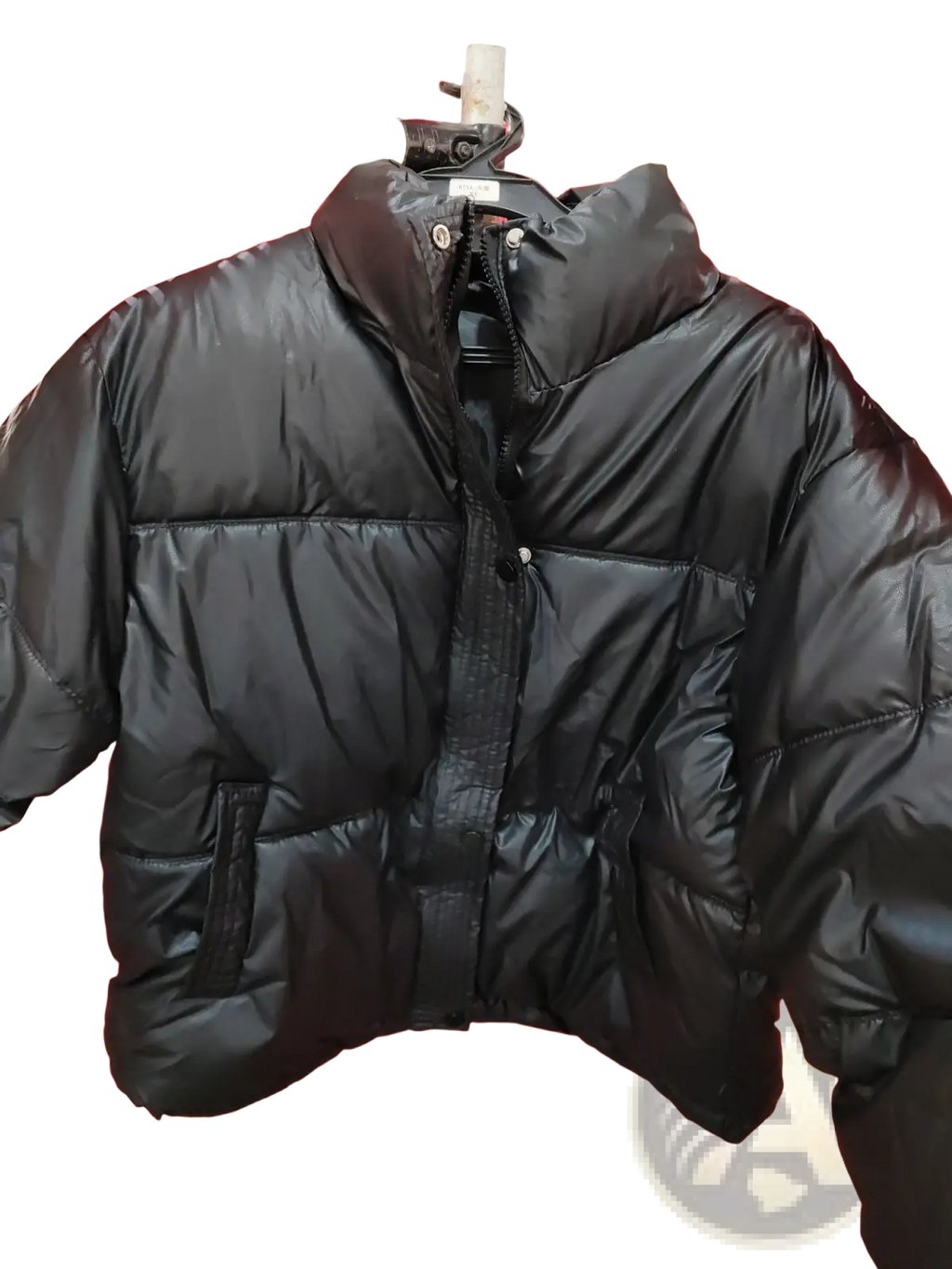 Women’s quilted puffer jacket in black with a shiny quilted exterior and a high collar for cold weather