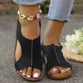 Black open-toe women’s recycled leather elastic summer wedge sandals with brown sole and gold zipper detail
