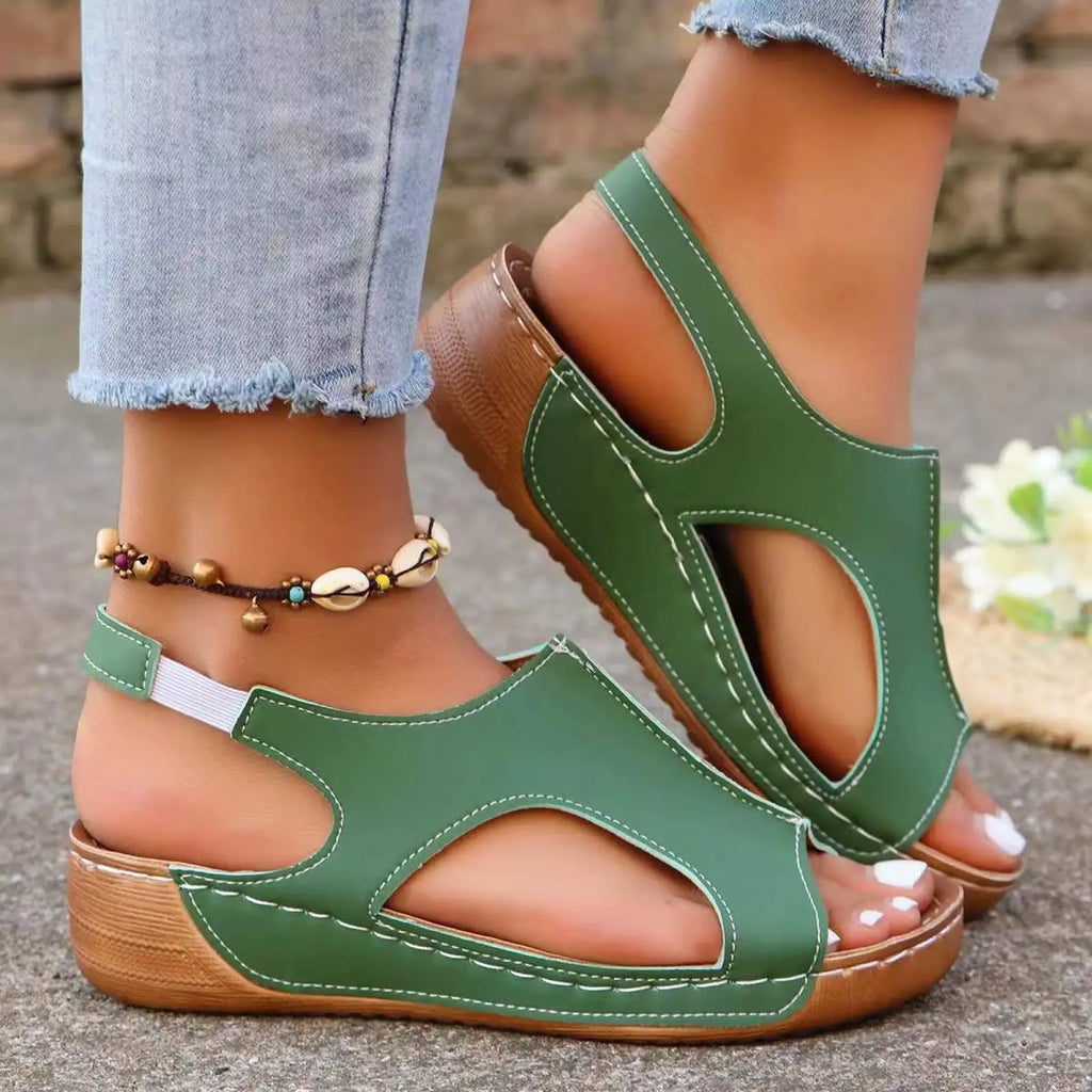 Green leather women’s elastic summer wedge sandals with wooden heel and white stitching displayed from back side