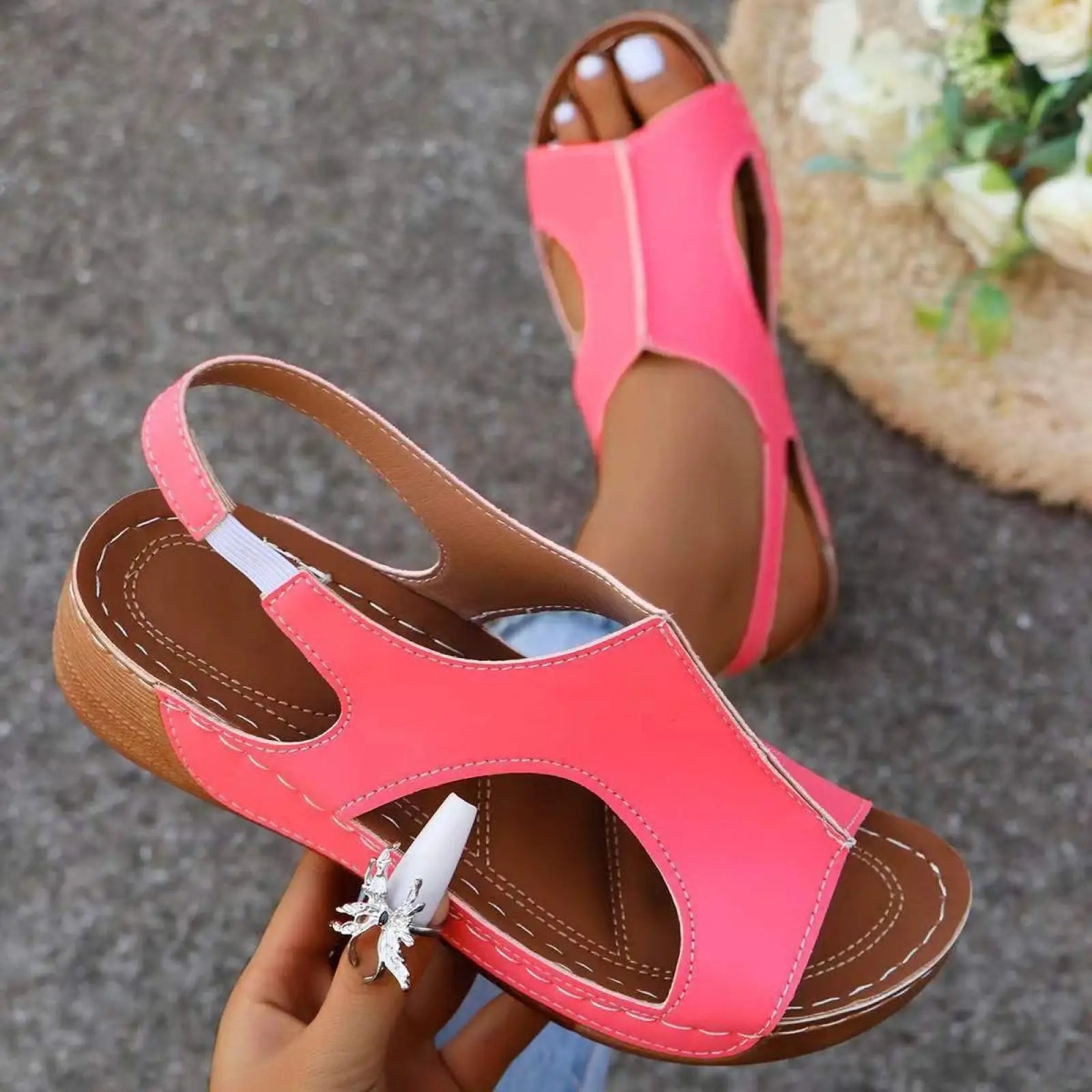 Bright pink women’s recycled leather elastic summer wedge sandal with brown leather interior and white stitching details