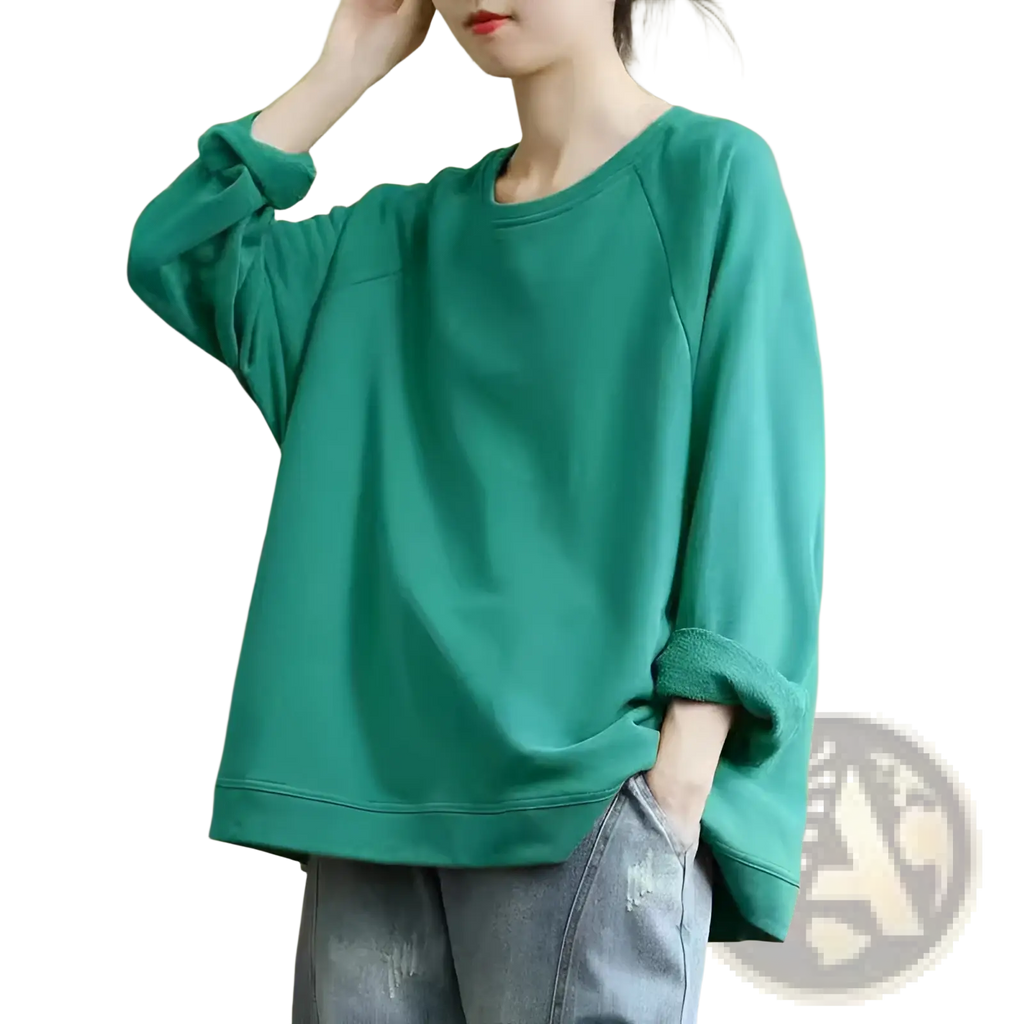 A soft teal women’s relaxed oversized cotton blend pullover sweatshirt with long sleeves and ribbed cuffs