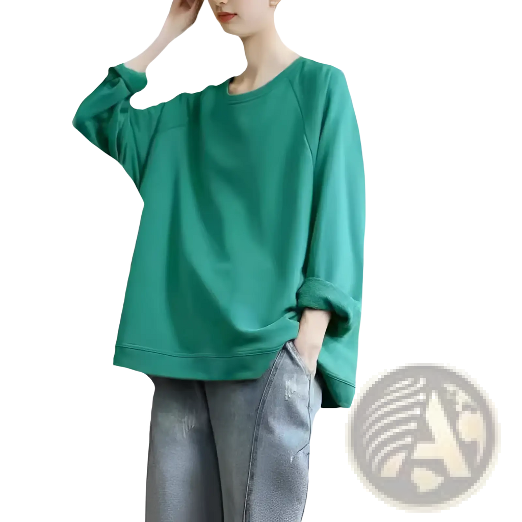 A soft teal-green women’s relaxed oversized cotton blend pullover sweatshirt with long sleeves and a relaxed fit