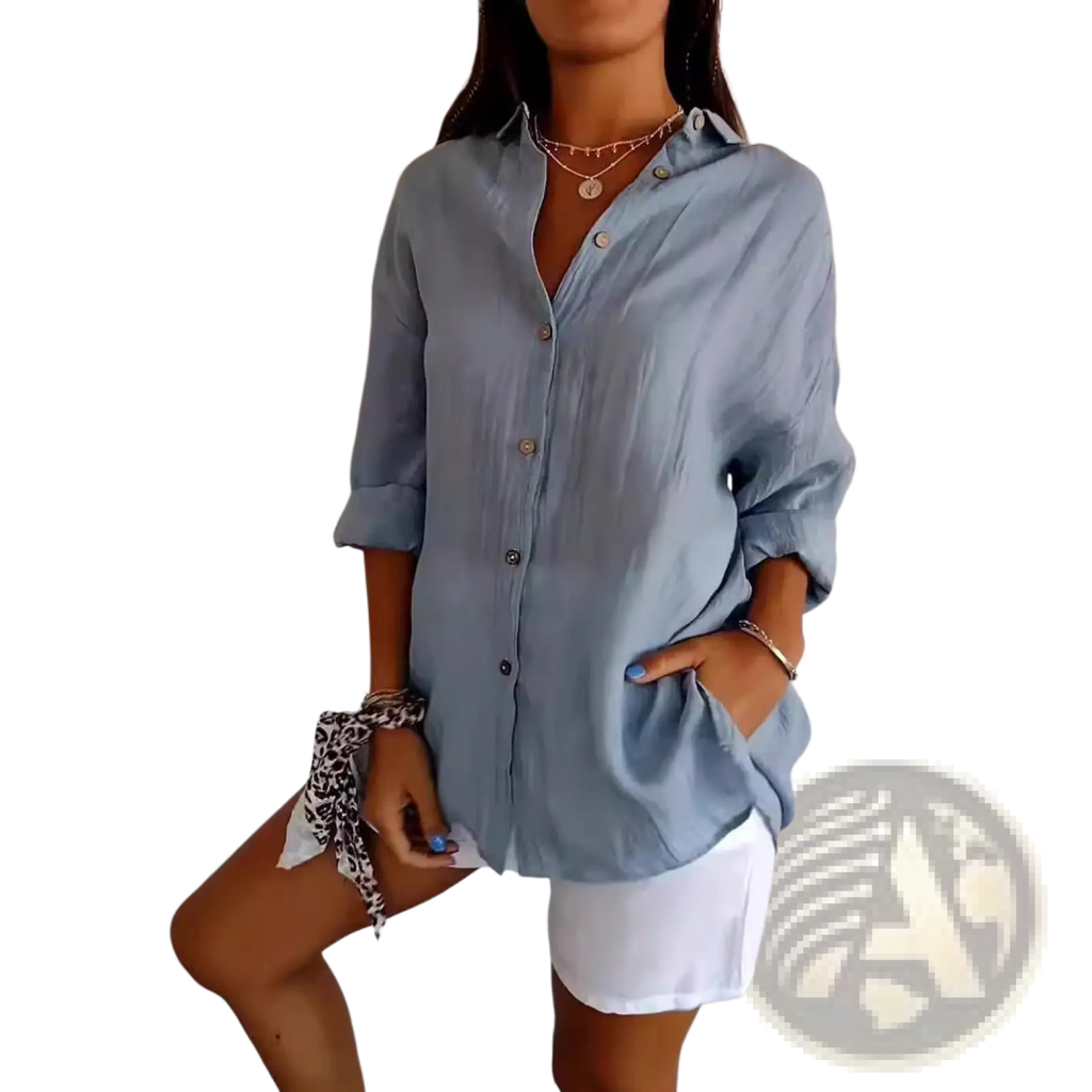 Light blue women’s relaxed pleated button up shirt with rolled sleeves and collar in loose-fitting fabric