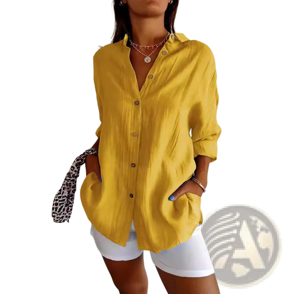 Yellow relaxed pleated button-up shirt for women with rolled sleeves made from lightweight fabric for casual wear