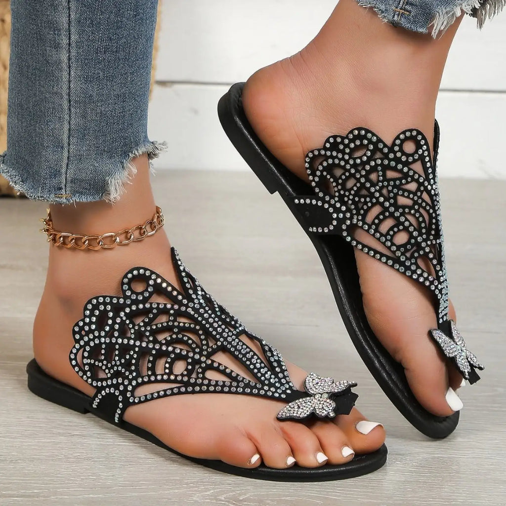 Women’s black rhinestone butterfly thong sandals with flat sole and hollow slip on design