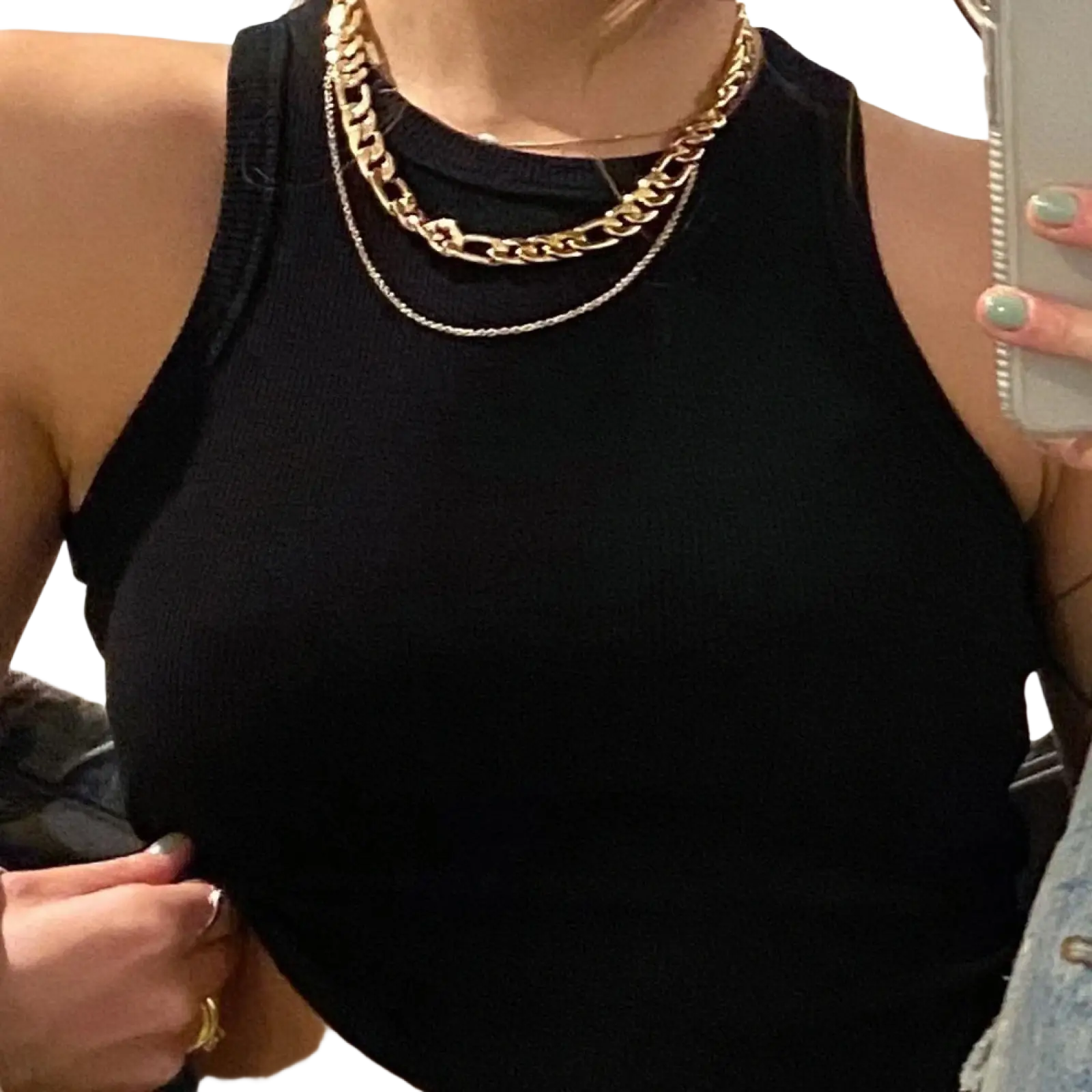 Woman wearing gold and silver layered chain necklaces over a black ribbed sleeveless slim fit crop top