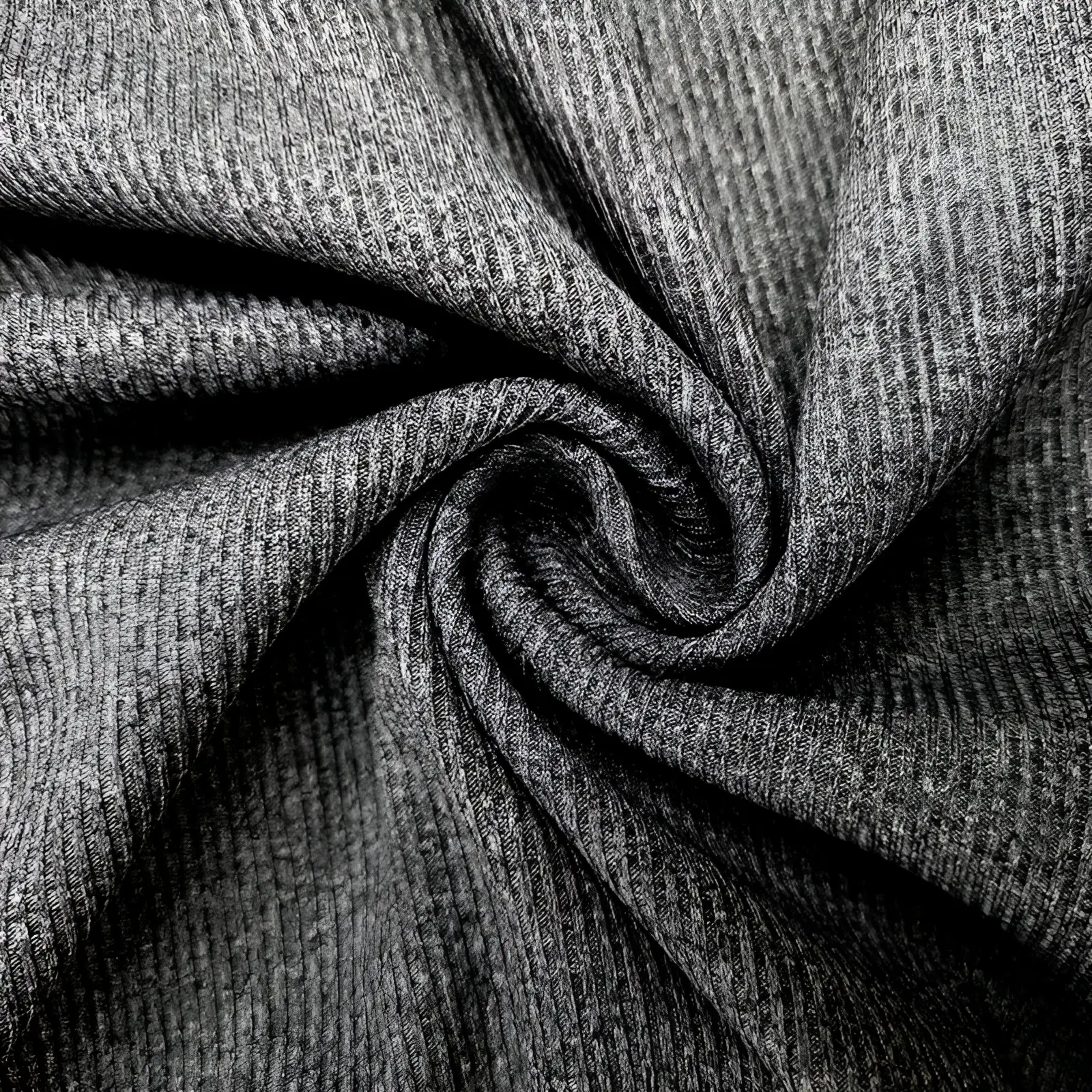 A close-up of a dark gray textured knit women’s ruffled ribbed slim fit mock neck top fabric detail