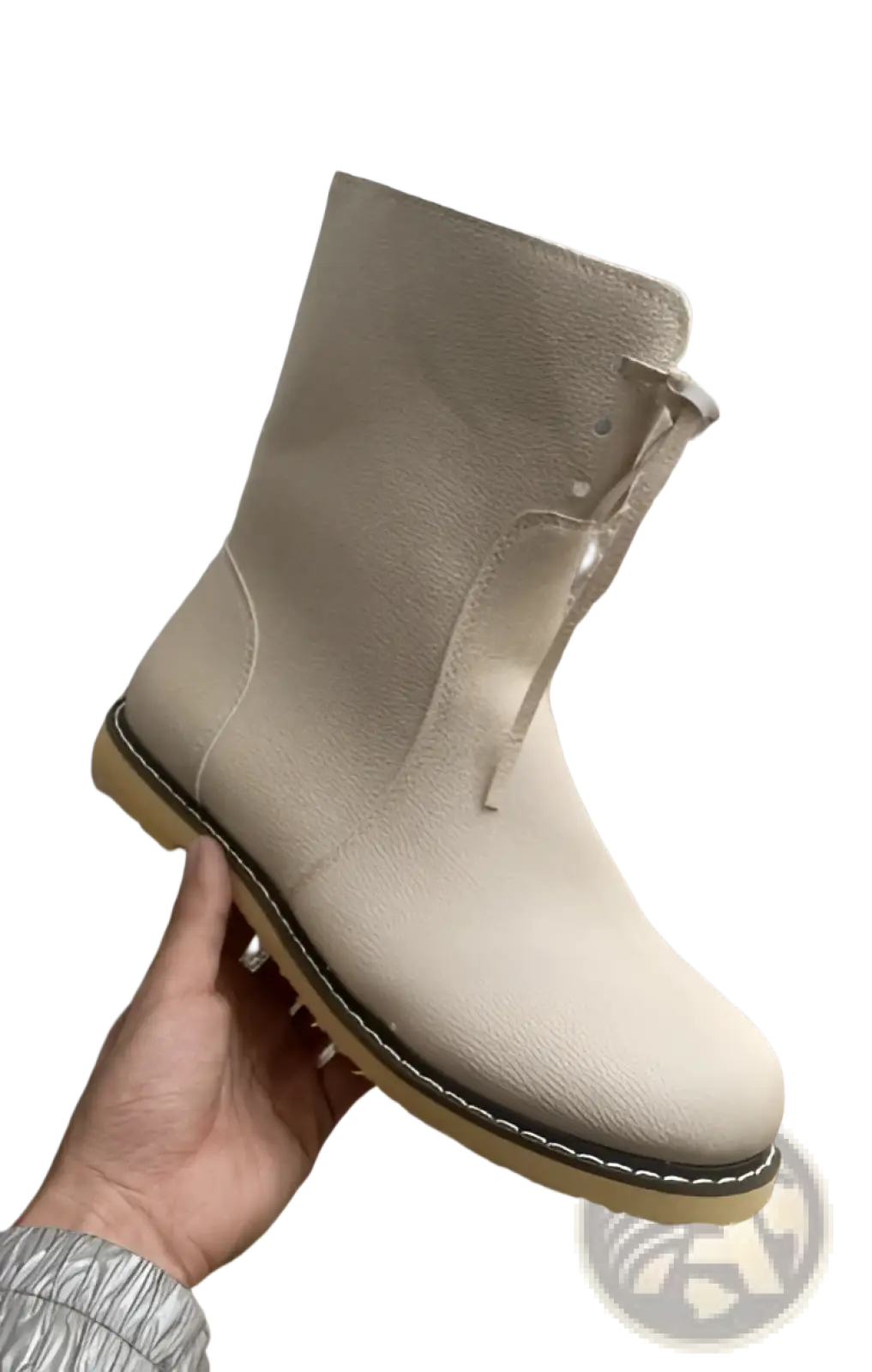Beige leather women’s shearling lined martin ankle boot with tan rubber sole and visible stitching shown from the back side