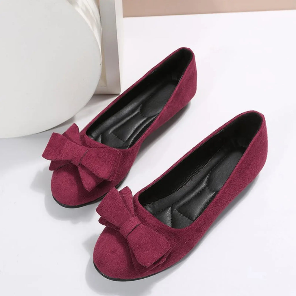 Women’s suede bow round toe flat gommino loafers in magenta with matching bow accents in suede material