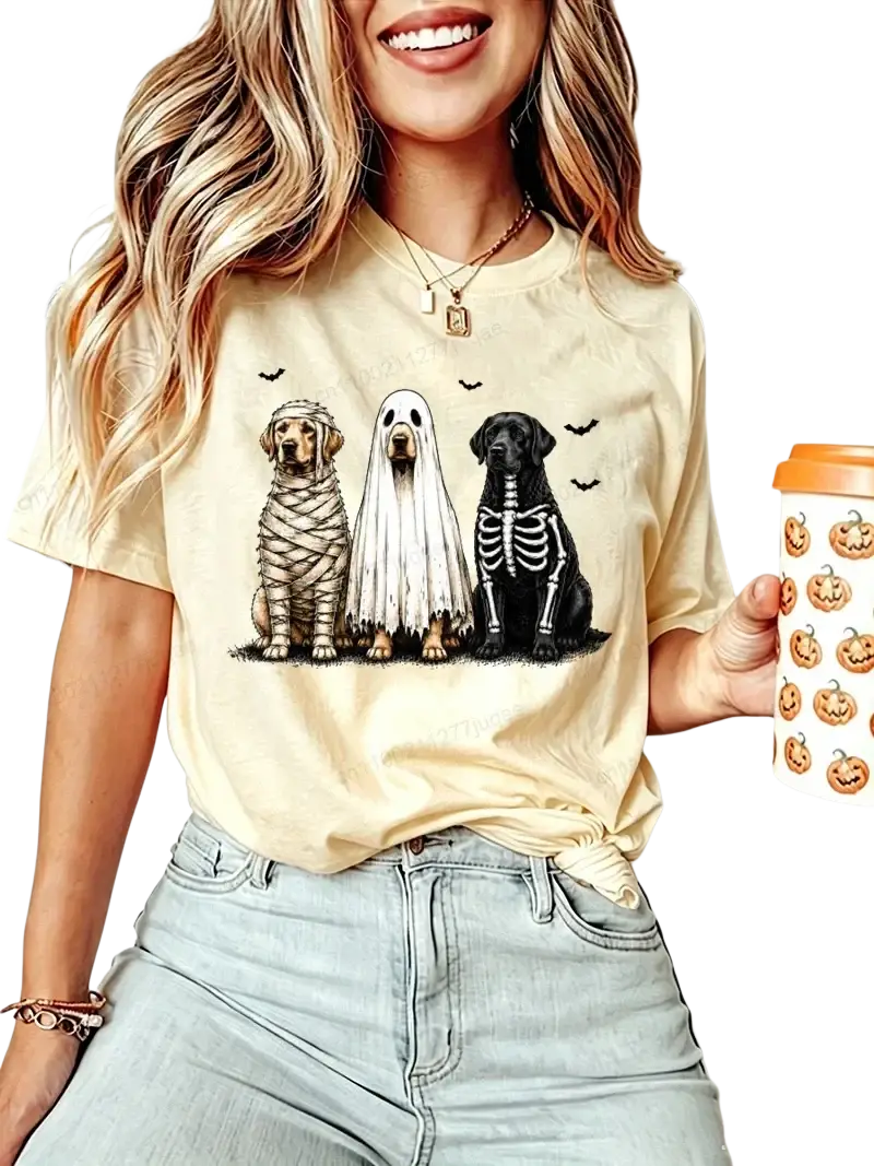 Beige short sleeve women’s t-shirt featuring halloween dog graphic with mummy ghost and skeleton costumes