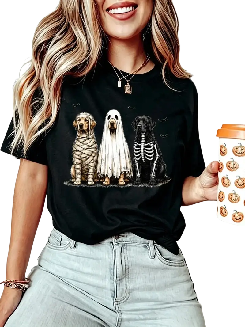 Black short sleeve women’s t-shirt featuring three dogs dressed as mummy ghost and skeleton halloween graphic tee