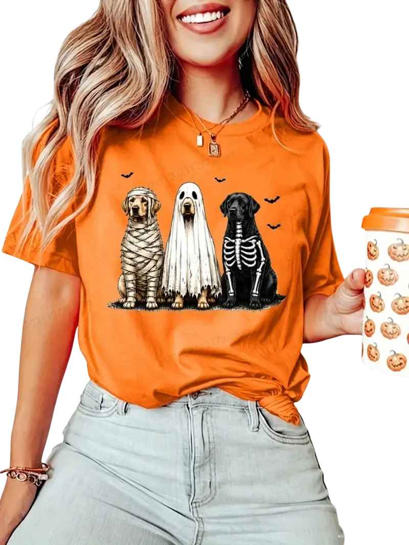 Orange short sleeve women’s t-shirt featuring a Halloween dog graphic with mummy ghost and skeleton costumes