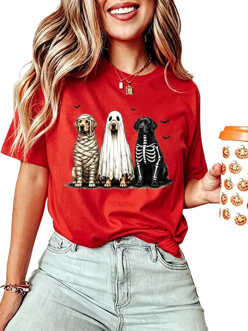 Red short sleeve women’s t-shirt featuring three dogs dressed as mummy ghost and skeleton for Halloween